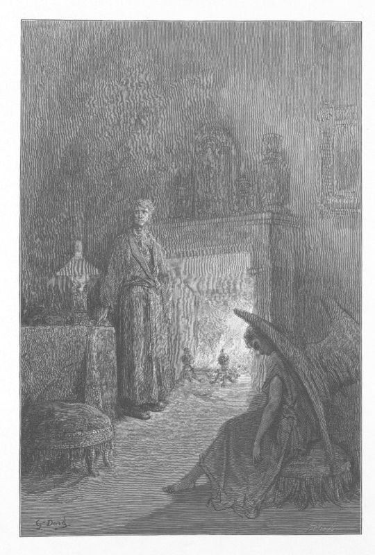 A woman stands upright beside a fireplace in a dark room. In front of the fire, a hooded figure crouches on the hearth with its back to us.